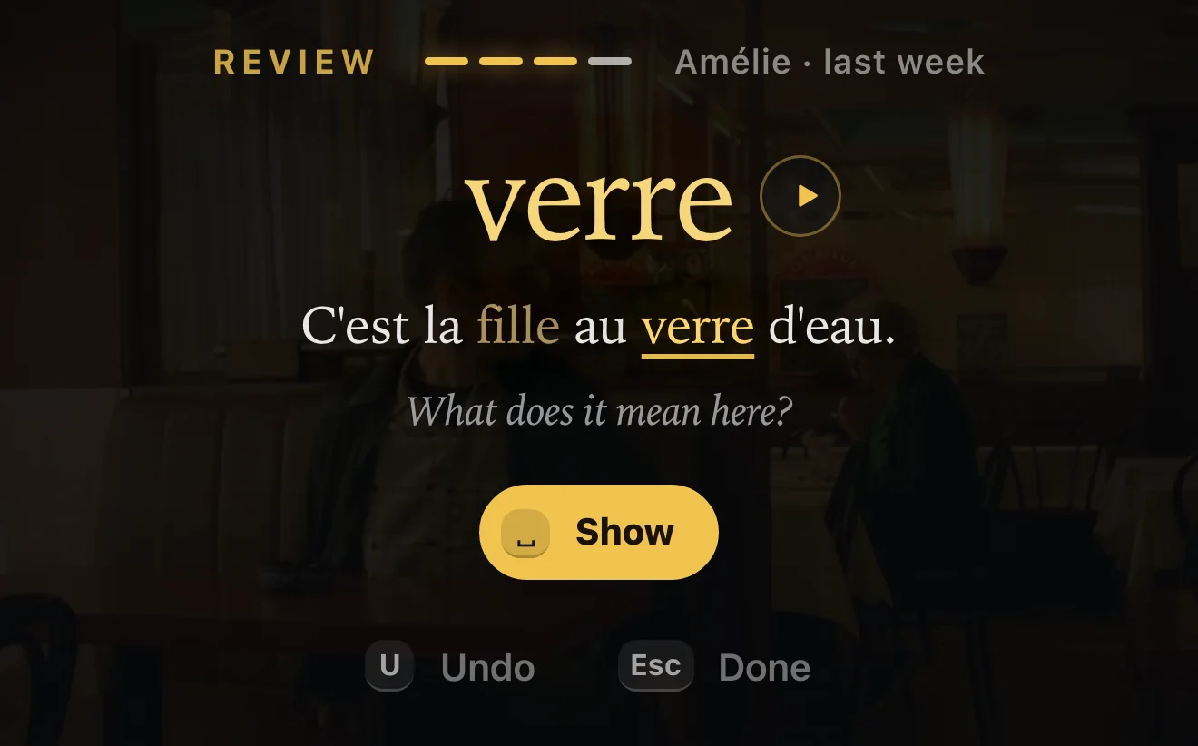 A StreamTutor review card: « verre » in gold above its line from Amélie, « C'est la fille au verre d'eau. », and the question “What does it mean here?”, with a Show button.